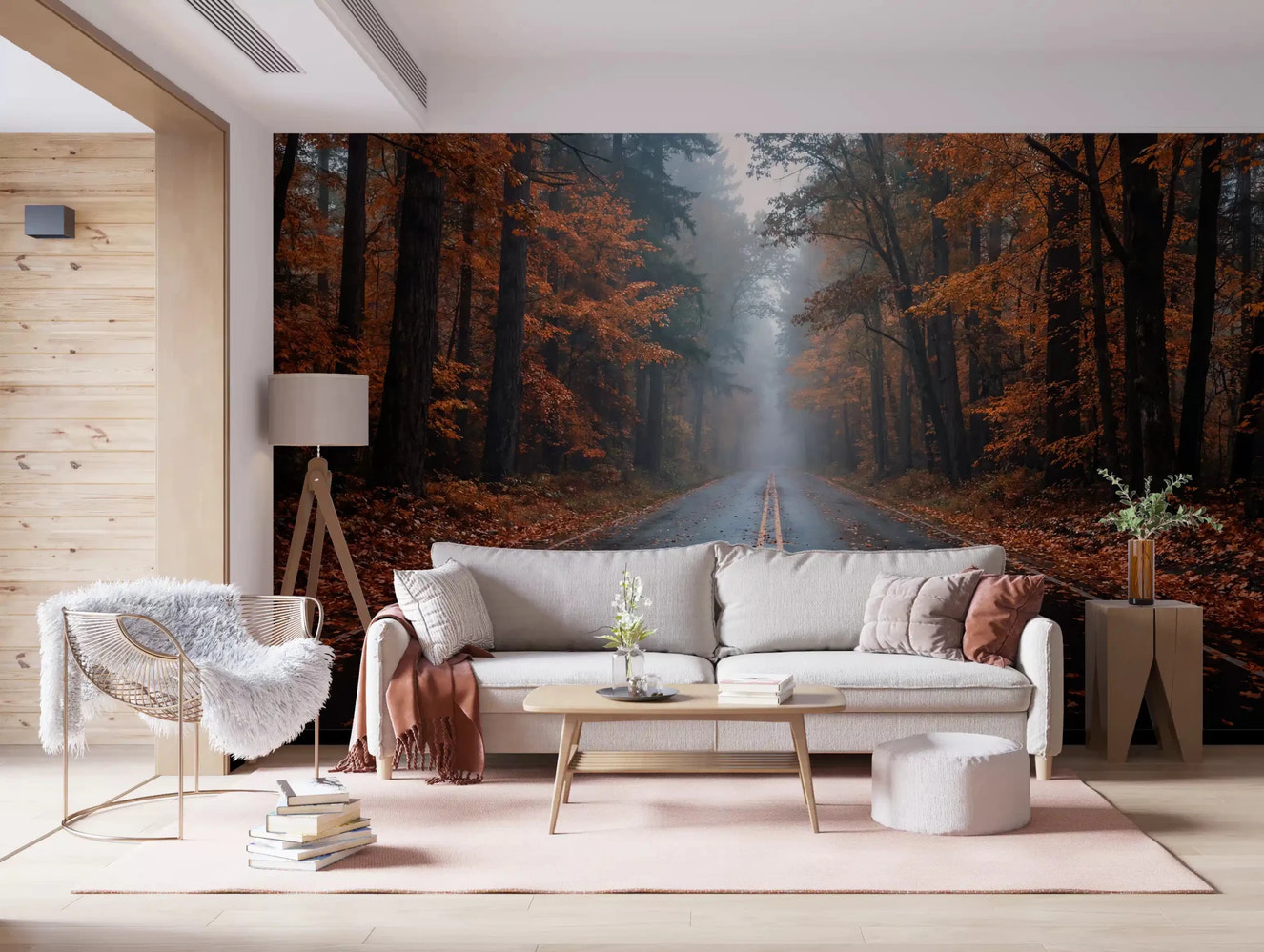 Living room with autumn forest road wall mural and misty tree-lined view