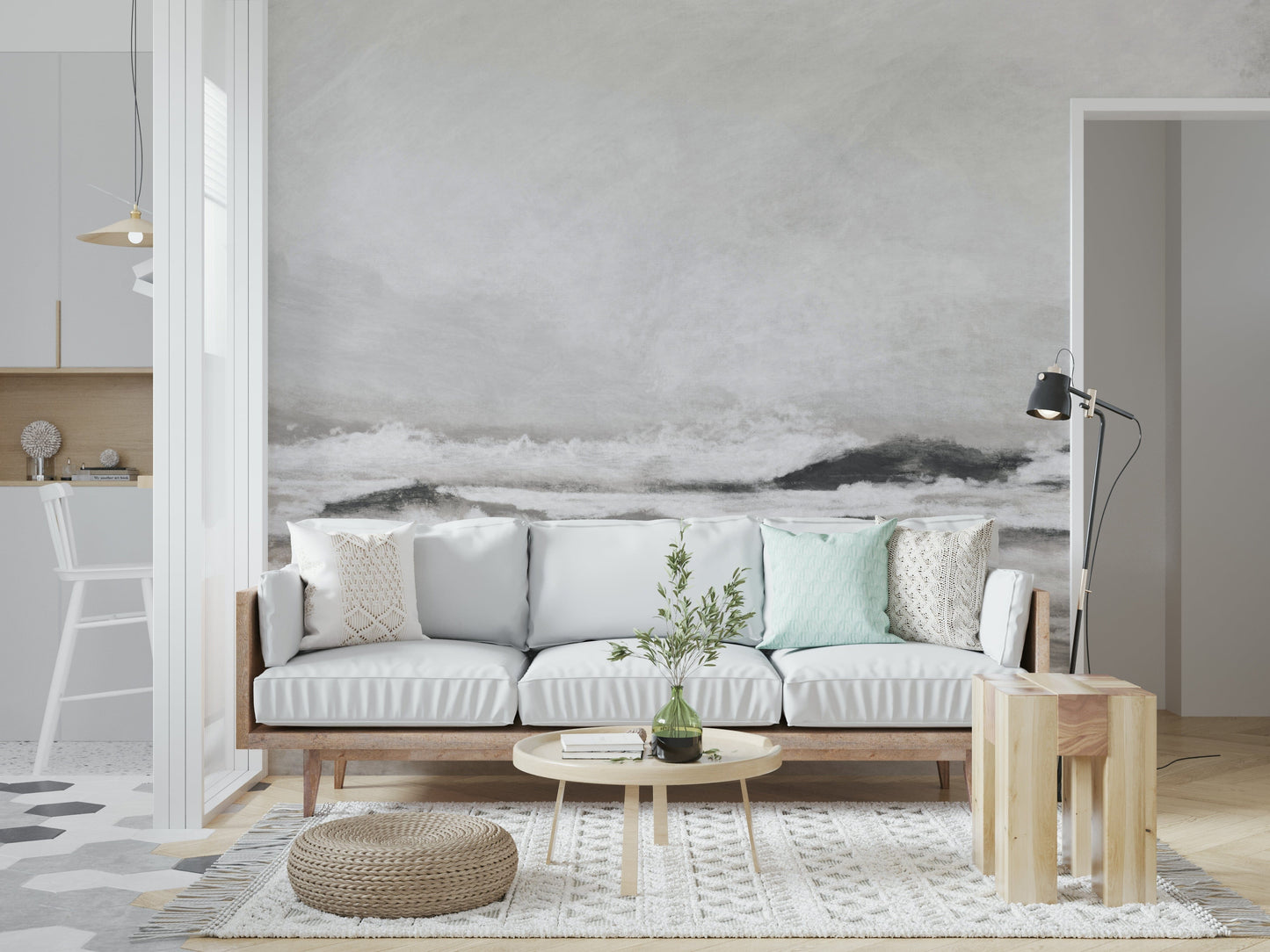 Misty Coast wallpaper mural of crashing grey waves above a white sofa with mint cushions in a Scandi living room
