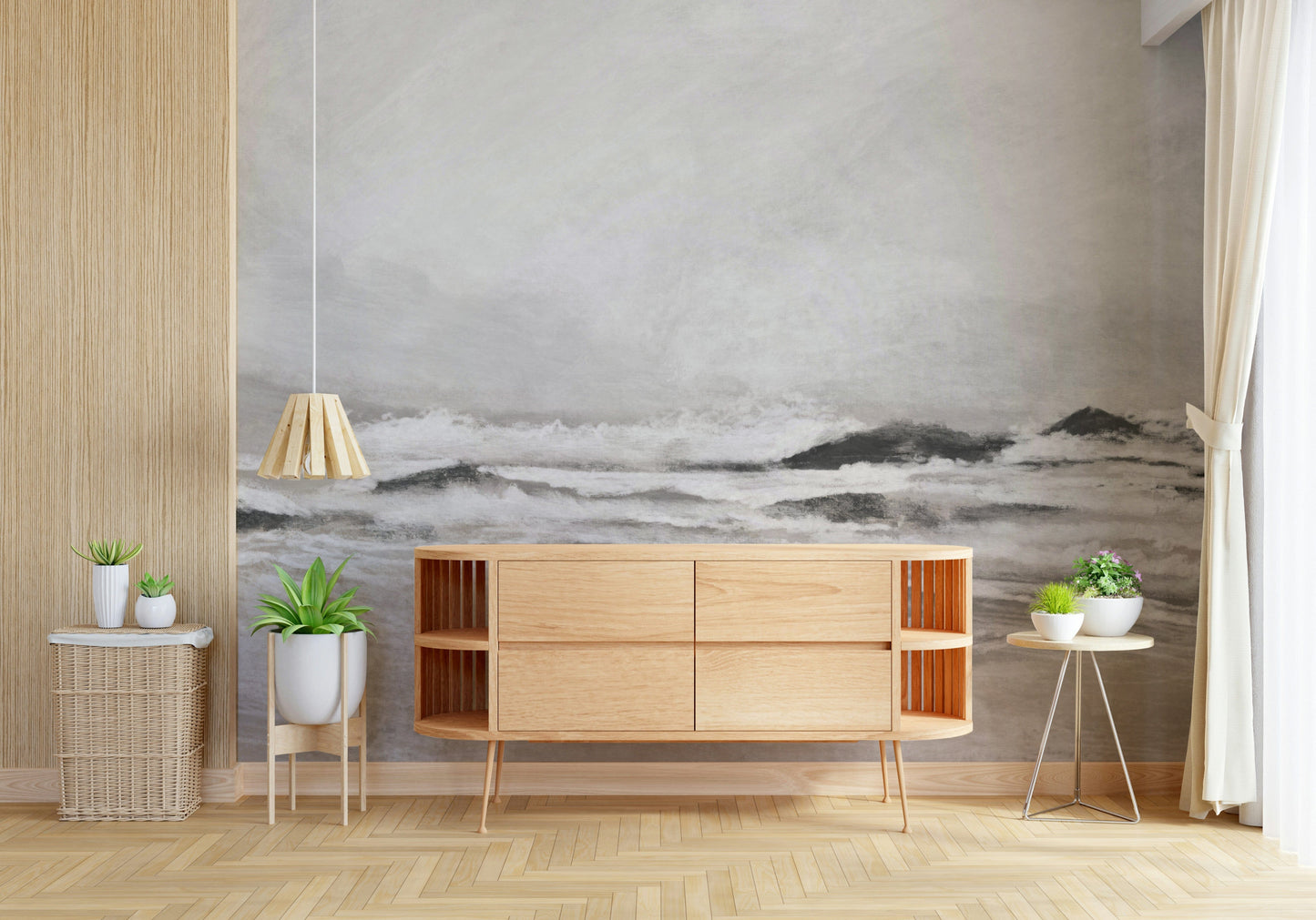 Misty Coast wallpaper mural of a grey seascape behind a light oak sideboard and potted plants in a living room