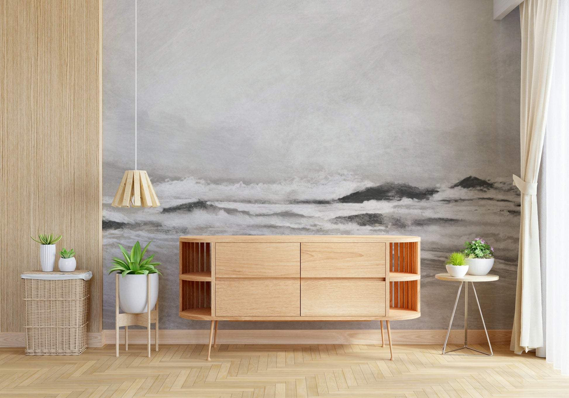 Misty Coast wallpaper mural of a grey seascape behind a light oak sideboard and potted plants in a living room