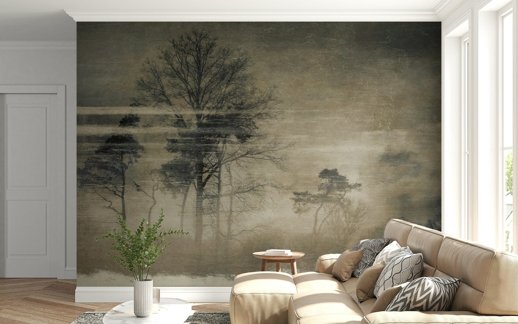 Ethereal Forest wallpaper mural with misty bare trees behind a beige sectional sofa in a bright living room