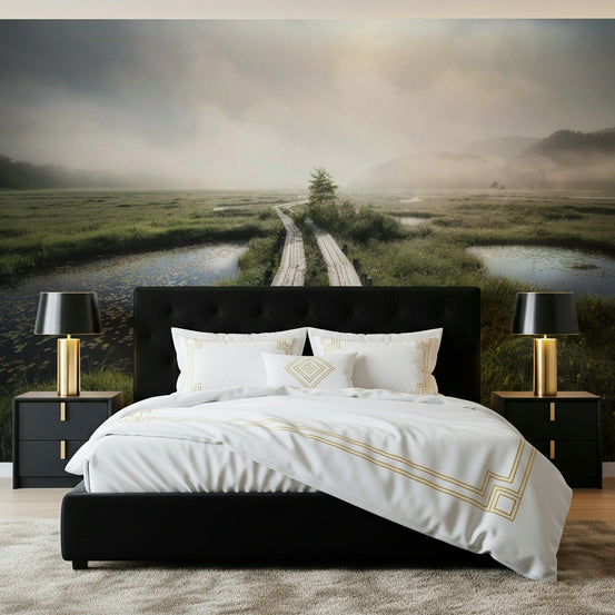 Ethereal Path wallpaper mural of a misty wetland boardwalk behind a black upholstered bed with gold lamps in a bedroom