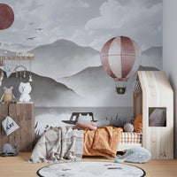 Soaring above misty peaks in a hot air balloon mural