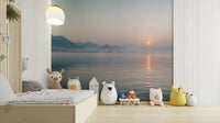 A wide shot of a wall mural showing a sunrise over a misty landscape.

