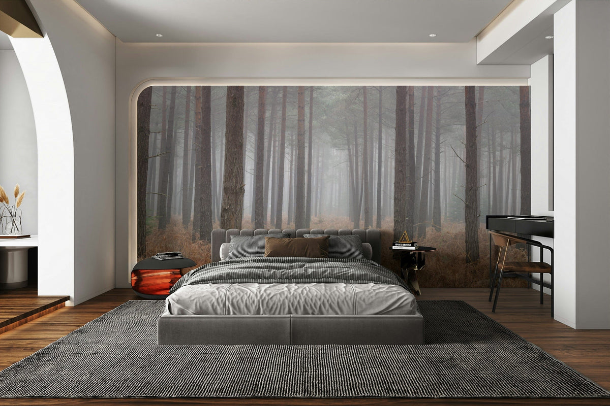 Misty Woodland Escape wallpaper mural of foggy pine trees and rust ferns behind a grey bed in a modern bedroom