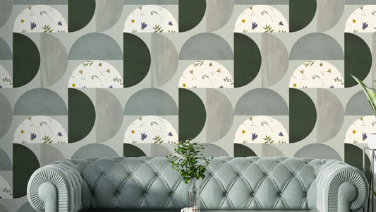 Modern Botanical Semicircles wallpaper mural in sage and green behind a tufted sage sofa in a living room