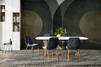 Modern Mid Century Charcoal Gold wallpaper mural with gold rings behind a white oval table and dark velvet chairs in a dining room