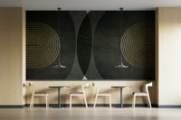 Modern Mid Century Charcoal Gold wallpaper mural with gold arches as a full-wall panel above pale wood bistro tables and chairs