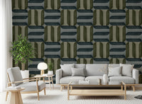 Modern Textured Signs Winter wallpaper in olive and blue-grey pattern behind a grey sofa and armchair in a bright living room