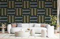 Modern Textured Signs Winter wallpaper in green and charcoal retro shapes behind a white curved boucle sofa in a living room