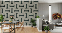Modern Textured Tiles Vintage Denim wallpaper behind a black dining table beside a grey living room sofa