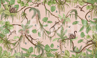 Monkey Business in Paradise wallpaper mural shown as a full-wall blush-pink scene of green foliage and brown squirrel monkeys