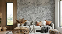 Monochromatic Striped Maze wall mural of swirling lines behind a grey sofa by a wood slat wall