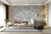 Monochromatic Striped Maze wall mural of woven black lines behind a grey sofa in a living room