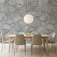 Monochromatic Striped Maze wall mural in black and white above a wood dining table in a dining room