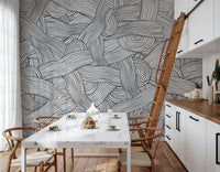 Monochromatic Striped Maze wall mural of swirling lines behind a marble table in a bright kitchen