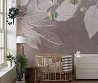 Monochrome Botanical Leaf wall mural with white leaves on mauve behind a round wooden crib and white dresser in a nursery