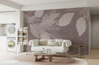 Monochrome Botanical Leaf wall mural with white leaves on mauve behind a plush white sofa in a bright living room