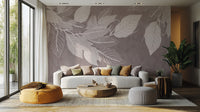 Monochrome Botanical Leaf wall mural with white leaves on mauve behind a curved cream sofa and mustard pouf in a living room