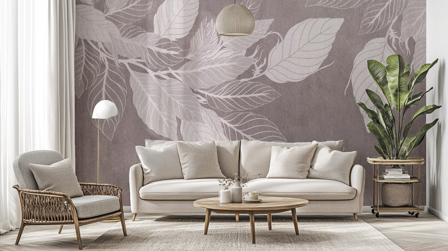 Monochrome Botanical Leaf wall mural with white leaves on mauve behind a cream sofa and woven chair in a living room