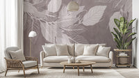 Monochrome Botanical Leaf wall mural with white leaves on mauve behind a cream sofa and woven chair in a living room