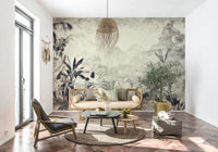 Monochrome Jungle Dream wallpaper mural of grey jungle behind a rattan daybed with an olive tree on terracotta tile