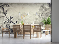 Monochrome Jungle Dream wallpaper mural in greyscale jungle above a wood dining table with rattan chairs and pendants