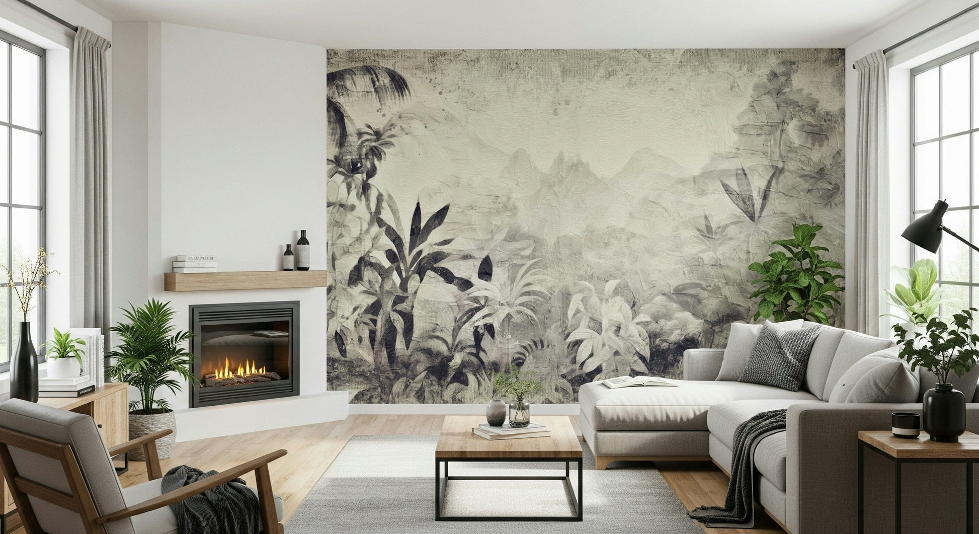 Monochrome Jungle Dream wallpaper mural in grey foliage beside a fireplace and grey sectional with leafy plants