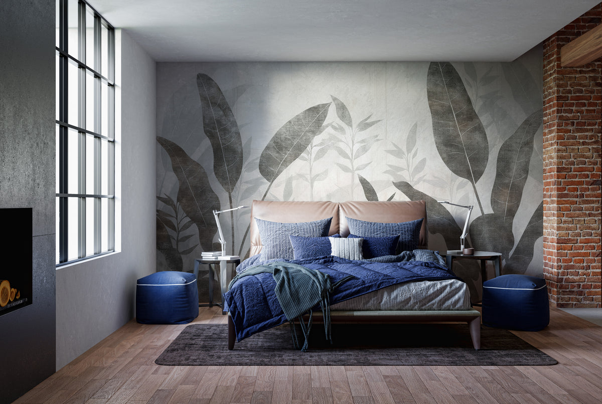 Monochrome Tropical Leaves wall mural behind a peach bed with blue bedding by exposed brick in a bedroom