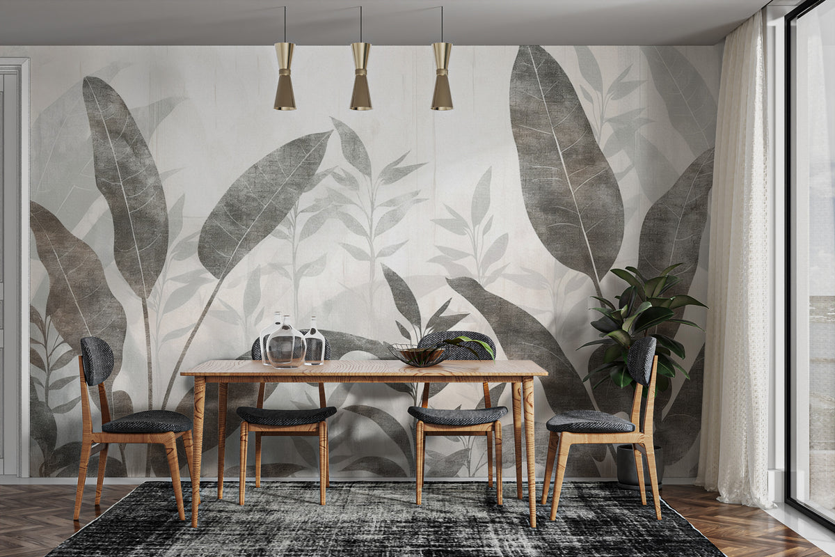 Monochrome Tropical Leaves wall mural behind a wood dining table with grey chairs and brass pendants