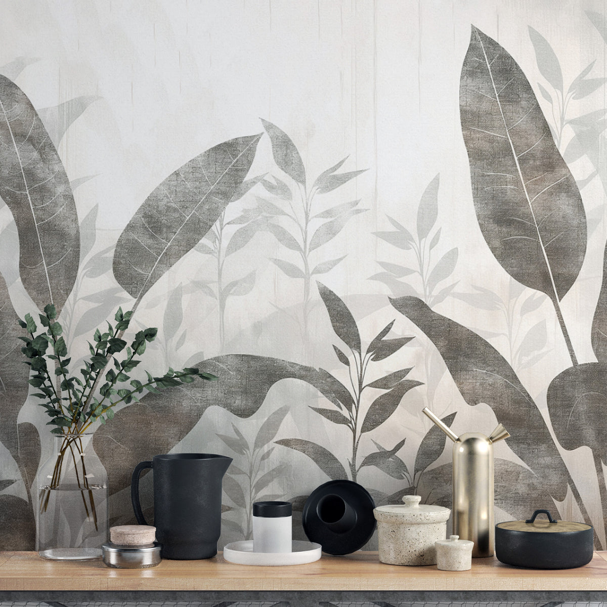 Monochrome Tropical Leaves wall mural close-up behind a styled shelf with black jugs and eucalyptus