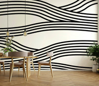 Elegant black-and-white wave patterns on a large mural.

