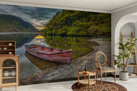 A close-up view shows the fine details of the boat and the rocky shore.

