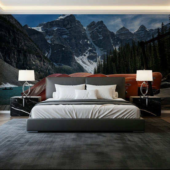 Moraine Lake Canoes wallpaper mural of red canoes and snowy peaks behind a grey platform bed in a bedroom