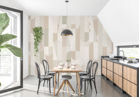 Mosaic Sepia Tones wallpaper of beige and sage shapes in a dining nook with a wooden table and black bentwood chairs