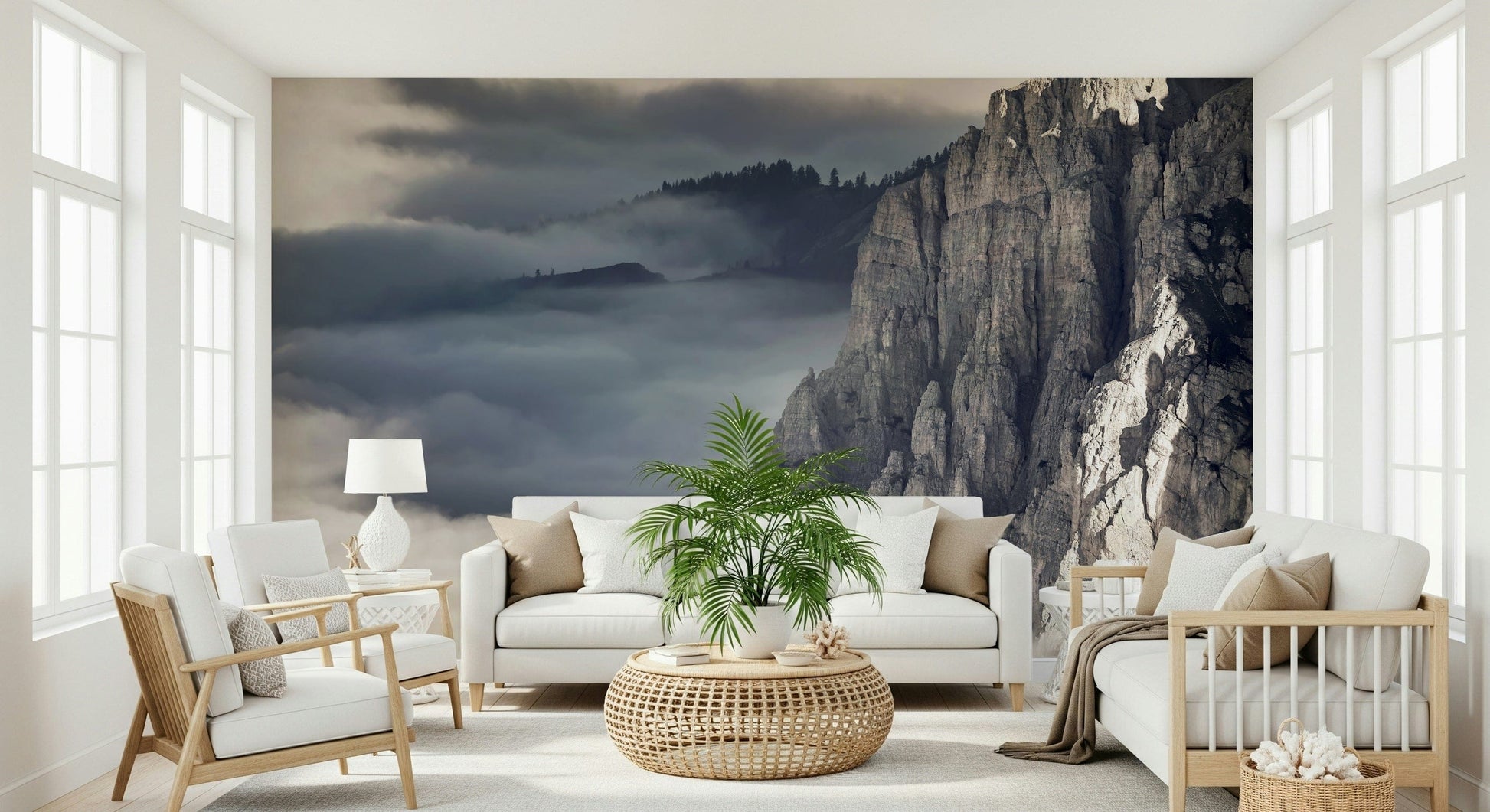Mountain Majesty wallpaper mural of cloudy mountain cliffs behind white sofas and a palm in a sunny living room