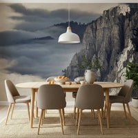 Mountain Majesty wallpaper mural of misty grey peaks behind an oval wood dining table and taupe chairs