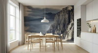 Mountain Majesty wallpaper mural of foggy cliffs behind a wood dining table in a bright white kitchen