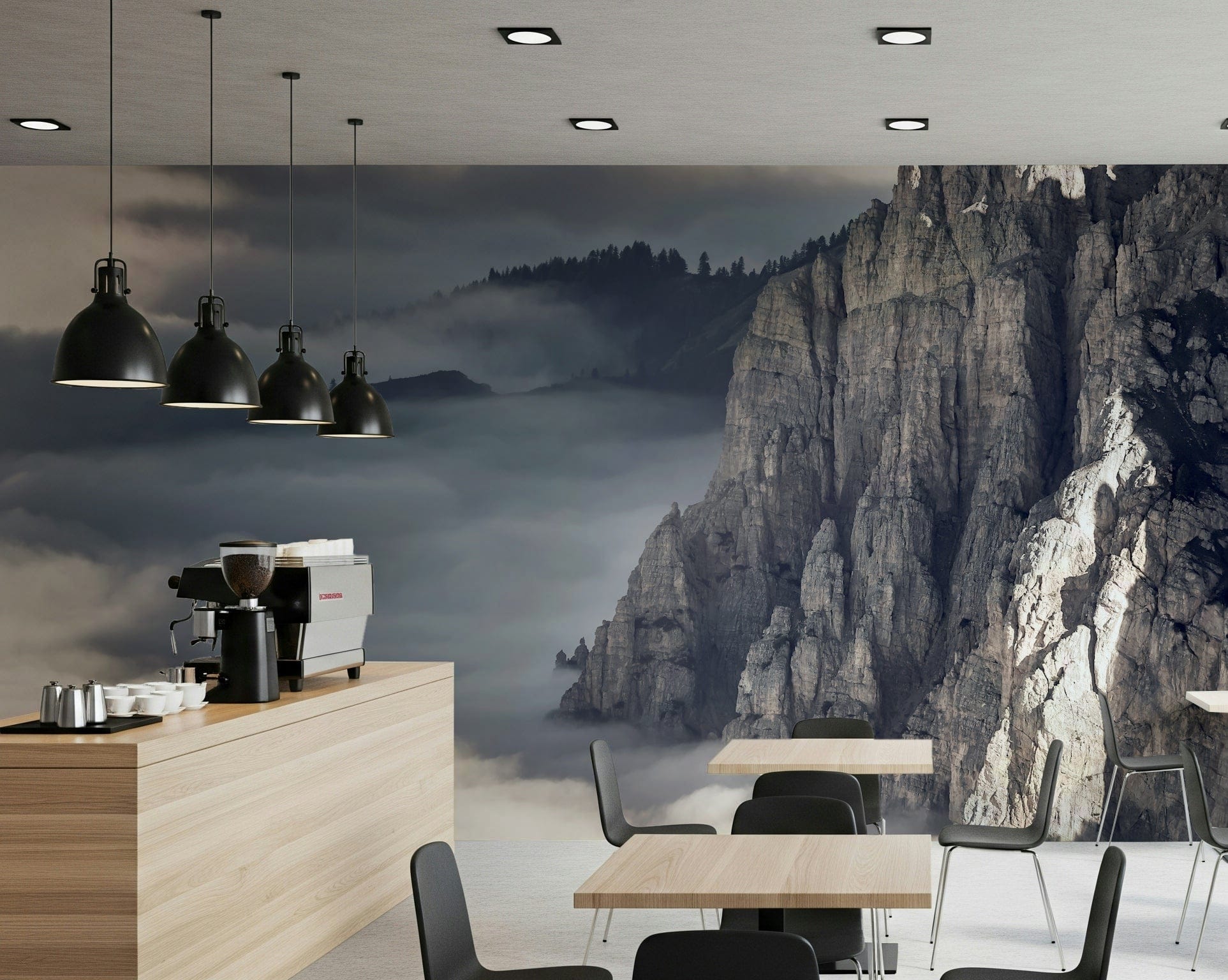 Mountain Majesty wallpaper mural of dramatic cliffs above clouds behind tables in a modern coffee shop