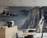 Mountain Majesty wallpaper mural of dramatic cliffs above clouds behind tables in a modern coffee shop