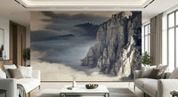 Mountain Majesty wallpaper mural of fog-filled peaks behind white sofas and a marble table in a living room