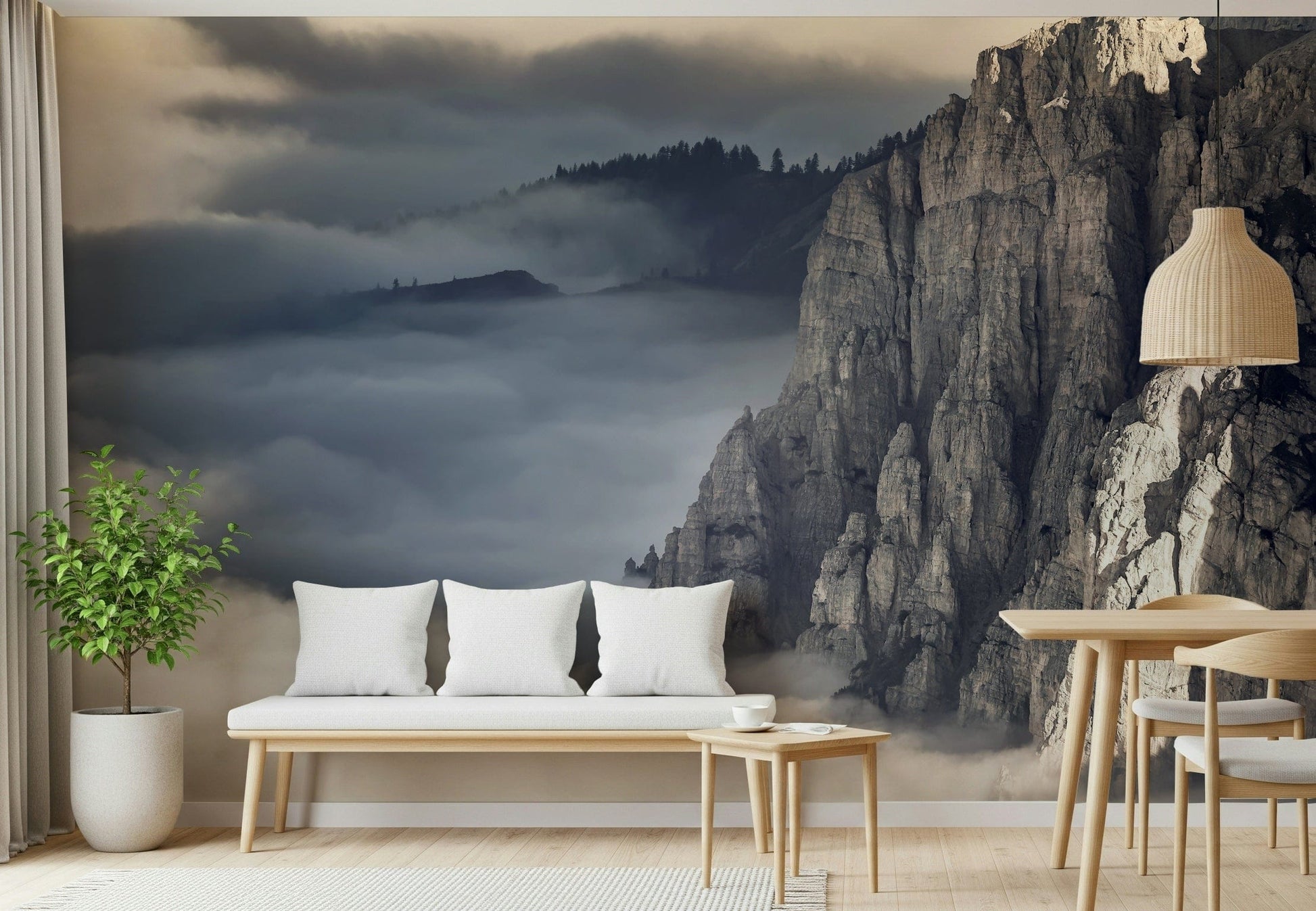 Mountain Majesty wallpaper mural of foggy cliffs above clouds behind a white bench in a living room