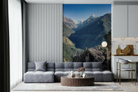Wall mural showcasing a dramatic mountain landscape with a small hut in the foreground.