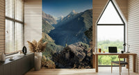 Alpine-style wall mural showing a hut overlooking dramatic mountain ridges and deep valleys.