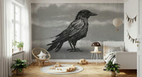 Mr Crow wall mural, a black raven on moody grey behind a pink ruffled bed in a girls bedroom