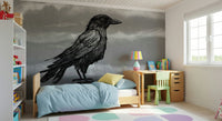 Mr Crow wall mural, a black raven on grey behind a beige sofa and wire chair in a living room