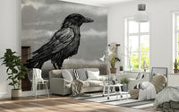 Mr Crow wall mural of an ink raven on moody grey behind a cream sofa in a bright living room