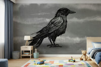 Mr Crow wall mural of a sketched raven on grey behind a wood bed and desk in a kids bedroom