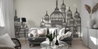 Mughal Palace wallpaper mural in grey behind a grey velvet sofa and tripod lamp in a living room