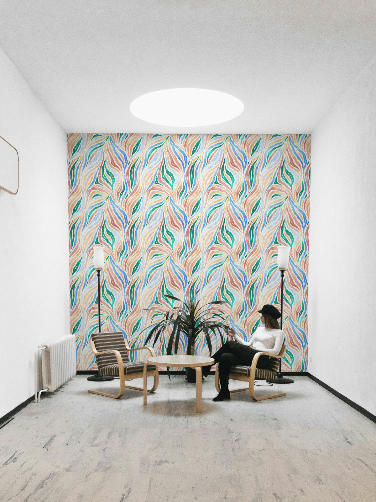 Multicolor Textured Boho Zebra Print wallpaper in a lounge with wood armchairs, a palm plant and skylight
